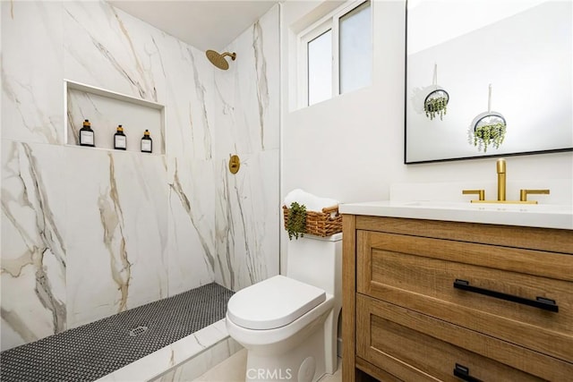 full bathroom with toilet, vanity, and a marble finish shower