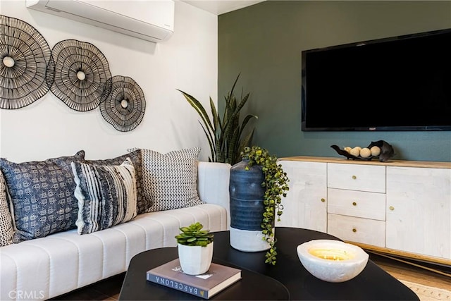living room featuring an AC wall unit and wood finished floors