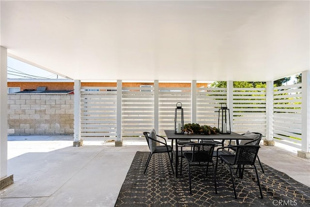 view of patio with outdoor dining area and fence