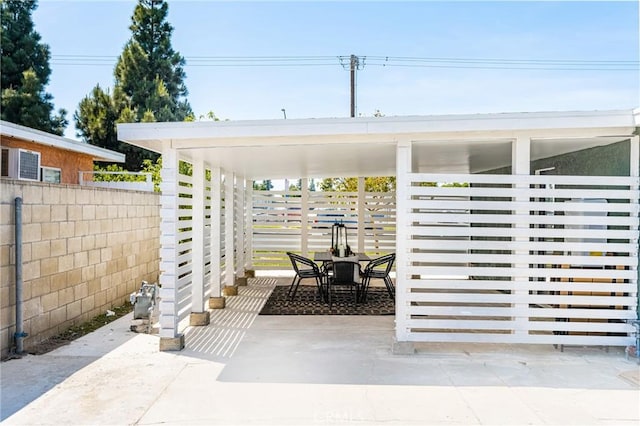 view of patio with fence and outdoor dining area