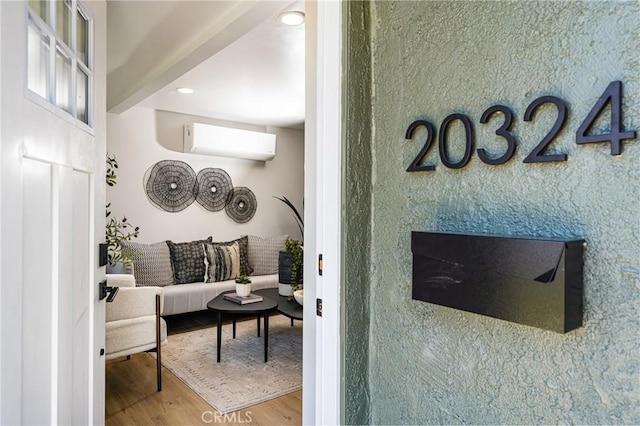 interior space featuring recessed lighting, an AC wall unit, and wood finished floors