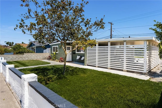 view of front of property with a front yard and fence