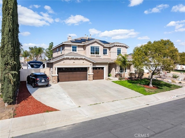 32460 Perigord Rd, Winchester, CA 92596 - view of front of house with stucco siding, an attached garage, solar panels, stone siding, and driveway