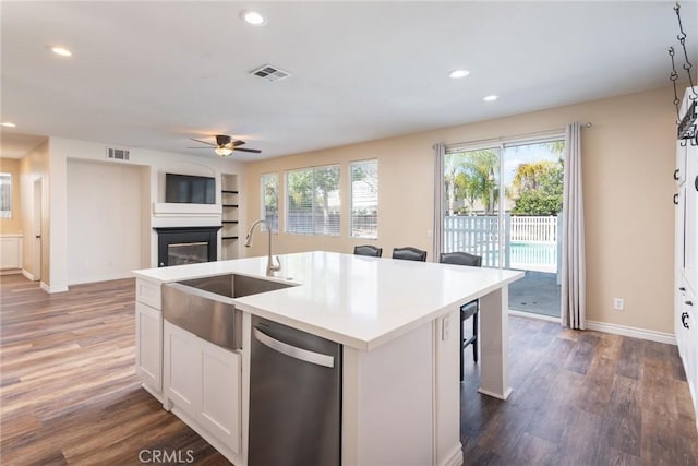 32460 Perigord Rd, Winchester, CA 92596 - kitchen featuring stainless steel dishwasher, a glass covered fireplace, ceiling fan, dark wood-style flooring, and recessed lighting