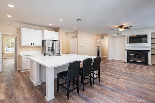 32460 Perigord Rd, Winchester, CA 92596 - kitchen featuring stainless steel fridge with ice dispenser, dark wood-style flooring, an island with sink, white cabinetry, and recessed lighting