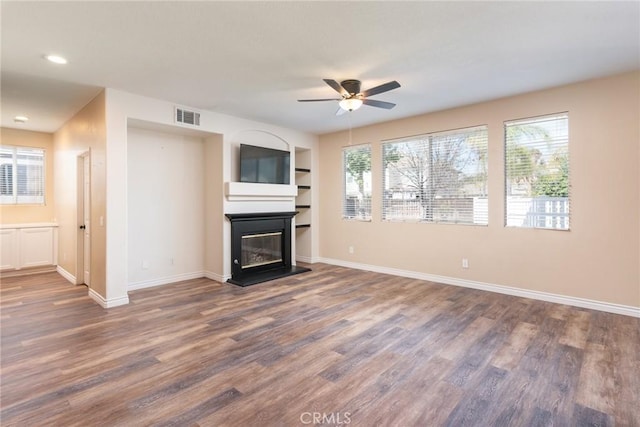 32460 Perigord Rd, Winchester, CA 92596 - unfurnished living room with ceiling fan, wood finished floors, a glass covered fireplace, and recessed lighting