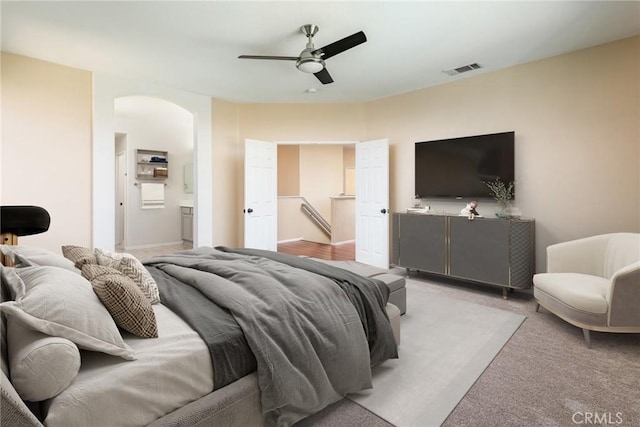 32460 Perigord Rd, Winchester, CA 92596 - bedroom featuring arched walkways, light carpet, and a ceiling fan