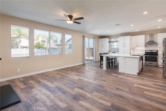 32460 Perigord Rd, Winchester, CA 92596 - kitchen with wall chimney exhaust hood, stainless steel appliances, a ceiling fan, white cabinetry, and recessed lighting