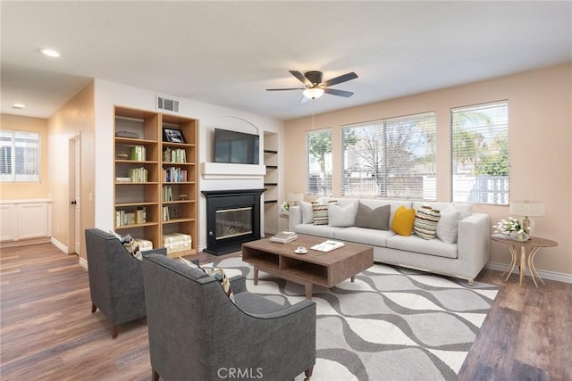 32460 Perigord Rd, Winchester, CA 92596 - living area with a glass covered fireplace, wood finished floors, ceiling fan, and recessed lighting