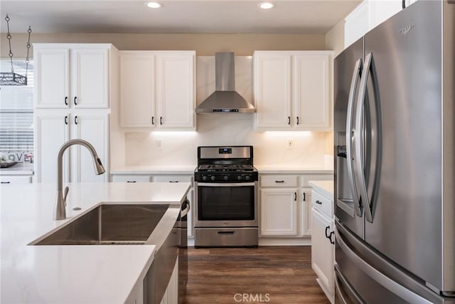 32460 Perigord Rd, Winchester, CA 92596 - kitchen with stainless steel appliances, wall chimney exhaust hood, recessed lighting, light countertops, and white cabinets