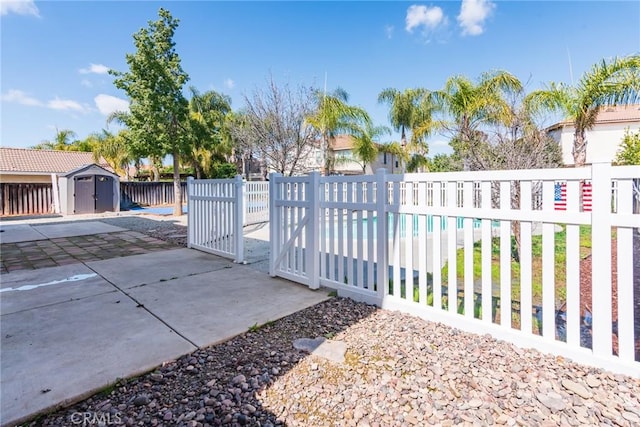32460 Perigord Rd, Winchester, CA 92596 - gate with a storage shed and a patio area