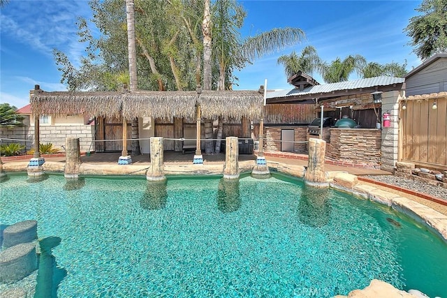 view of swimming pool with a fenced in pool, a patio, and area for grilling