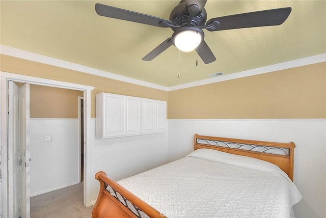 bedroom featuring light carpet, ceiling fan, crown molding, and visible vents