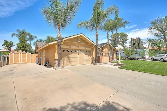 single story home with a storage shed, an attached garage, concrete driveway, stucco siding, and a front lawn