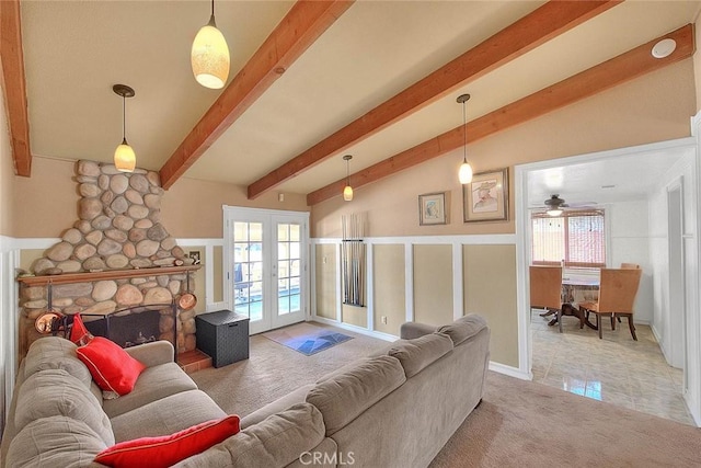 carpeted living area featuring french doors, a wealth of natural light, vaulted ceiling with beams, and ceiling fan
