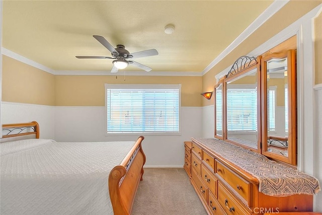 bedroom featuring light carpet, baseboards, crown molding, and a ceiling fan