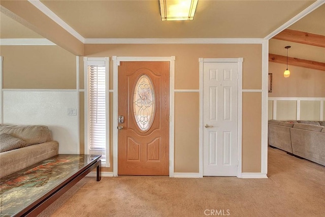 entryway with light colored carpet, crown molding, and a healthy amount of sunlight