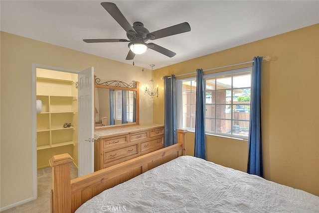 bedroom with a spacious closet, ceiling fan, a closet, and carpet floors