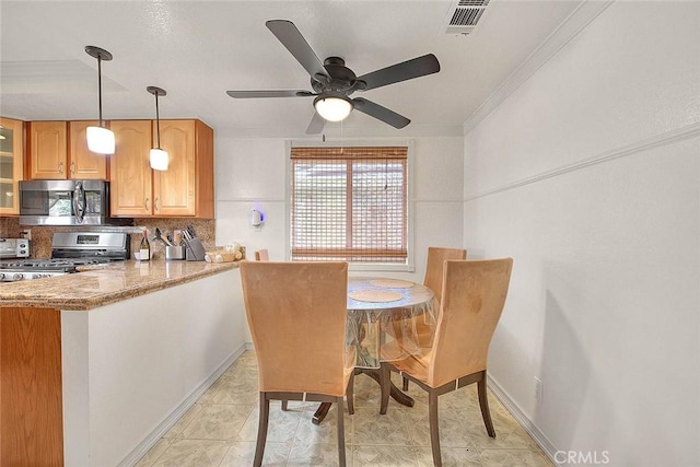 kitchen with tasteful backsplash, a ceiling fan, visible vents, appliances with stainless steel finishes, and pendant lighting