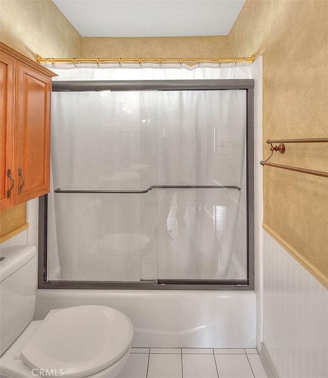 full bathroom featuring tile patterned floors, shower / bath combination with glass door, and toilet