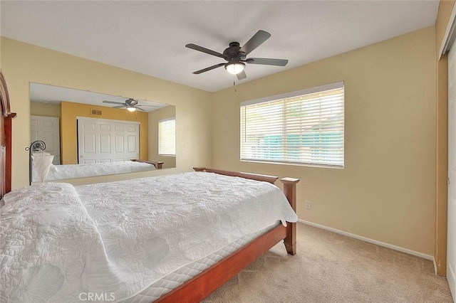 bedroom featuring a closet, baseboards, carpet flooring, and ceiling fan