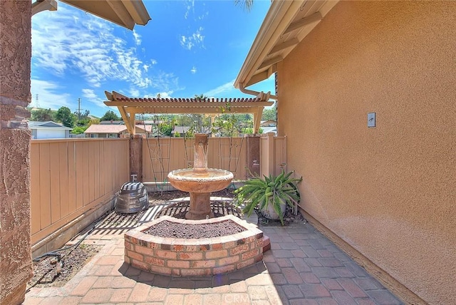 view of patio / terrace featuring fence and a pergola