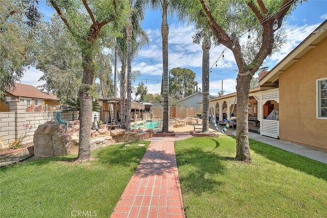 view of yard featuring a patio area and a fenced backyard