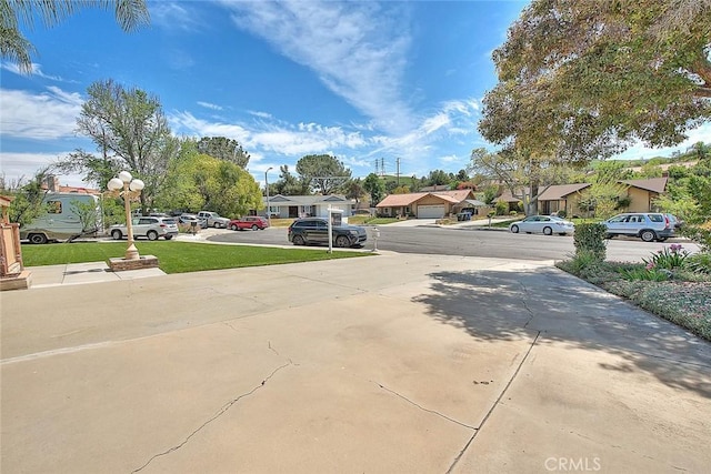 view of road with a residential view and driveway