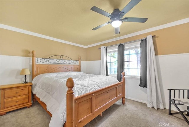 carpeted bedroom with crown molding and ceiling fan