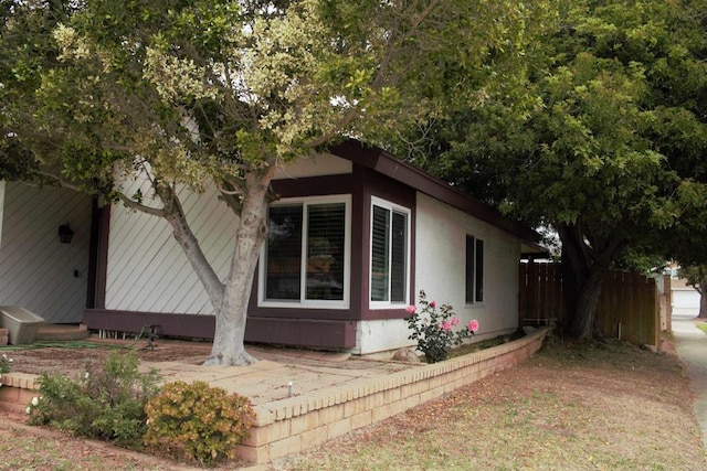 view of side of property with fence