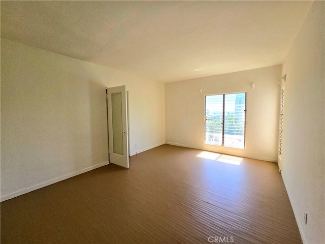 empty room featuring baseboards