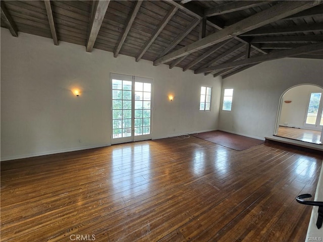 interior space featuring wood ceiling, wood-type flooring, arched walkways, and beamed ceiling