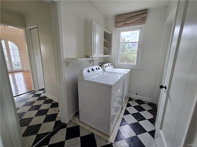 laundry area with baseboards, a wealth of natural light, tile patterned floors, and washer and dryer
