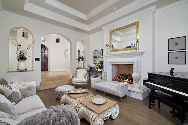 18320 Colina Fuerte, Rancho Santa Fe, CA 92067 - living area with wood finished floors, arched walkways, a lit fireplace, crown molding, and a raised ceiling