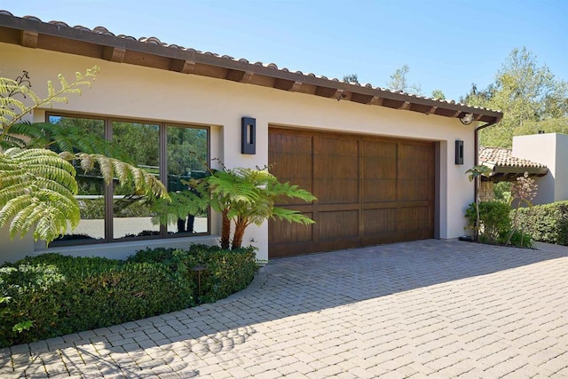 18320 Colina Fuerte, Rancho Santa Fe, CA 92067 - view of front of house featuring a garage, decorative driveway, and stucco siding