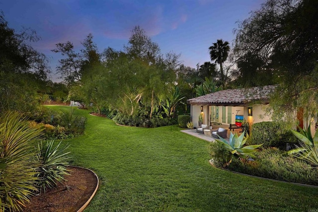 18320 Colina Fuerte, Rancho Santa Fe, CA 92067 - yard at dusk featuring a lawn and a patio