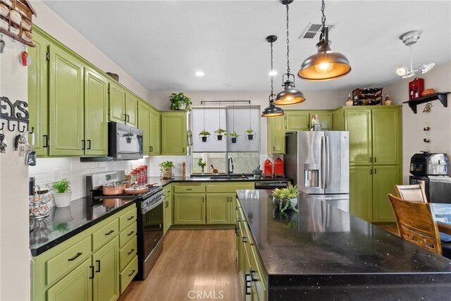 13126 Glandt Ct, Corona, CA 92883 - kitchen with a kitchen island, black appliances, visible vents, green cabinetry, and a sink