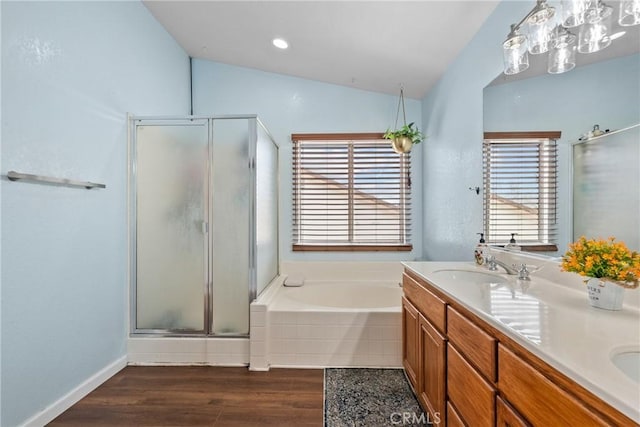 13126 Glandt Ct, Corona, CA 92883 - bathroom featuring double vanity, vaulted ceiling, a stall shower, a garden tub, and wood finished floors