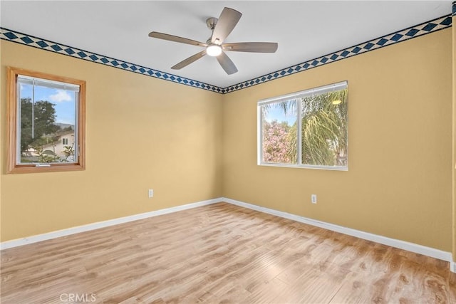13126 Glandt Ct, Corona, CA 92883 - empty room featuring plenty of natural light, baseboards, and wood finished floors
