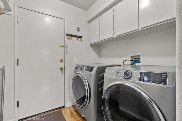 13126 Glandt Ct, Corona, CA 92883 - laundry area with light wood-style flooring, washing machine and clothes dryer, and cabinet space
