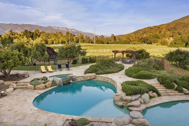 561 Saddle Ln, Ojai, CA 93023 - view of pool with a mountain view, fence, a patio, a pool with connected hot tub, and a pergola