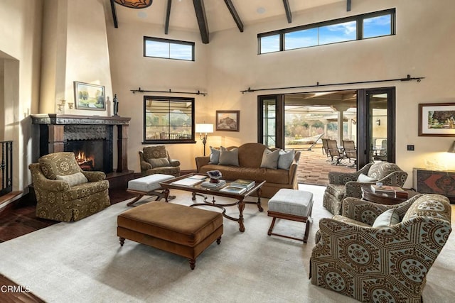 561 Saddle Ln, Ojai, CA 93023 - living area featuring beam ceiling, a warm lit fireplace, and high vaulted ceiling