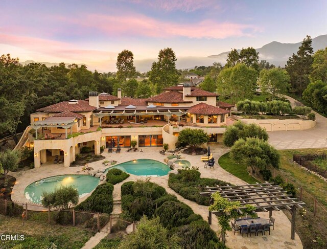 561 Saddle Ln, Ojai, CA 93023 - back of house with a balcony, a patio area, a fenced in pool, and a fenced backyard