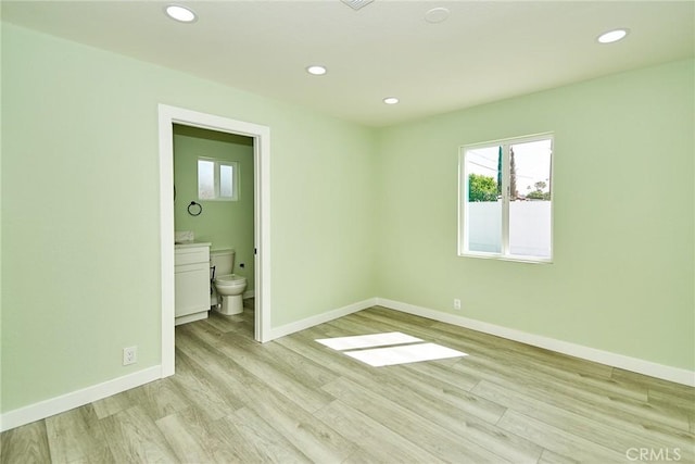 unfurnished bedroom with recessed lighting, baseboards, multiple windows, and light wood-style floors