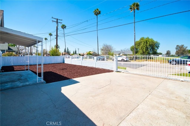 view of patio featuring fence and a gate