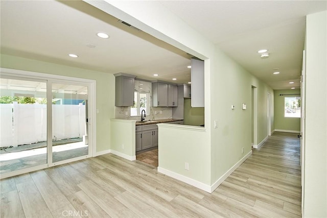 kitchen with recessed lighting, gray cabinetry, and light wood-style flooring