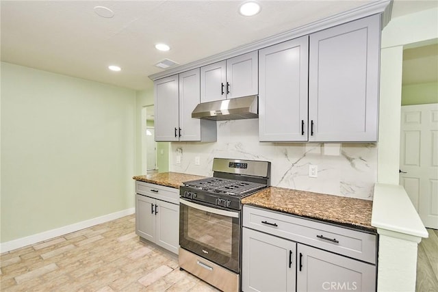 kitchen with baseboards, recessed lighting, under cabinet range hood, visible vents, and stainless steel gas stove