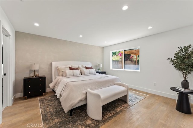 bedroom featuring recessed lighting, light wood finished floors, and baseboards