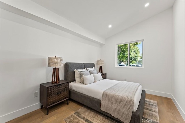 bedroom featuring recessed lighting, lofted ceiling, light wood finished floors, and baseboards