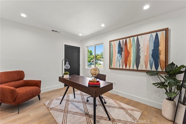 home office featuring light wood finished floors, baseboards, visible vents, and recessed lighting